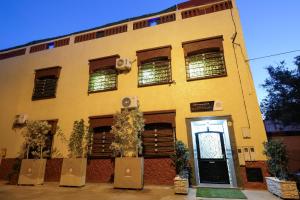 a yellow building with a door in front of it at Authentic Berber Studio in Benguerir