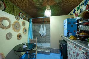 a kitchen with a small table and a shower at Authentic Berber Studio in Benguerir +3 photos