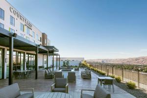 a hotel with a patio with tables and chairs at Courtyard Lewiston in Lewiston
