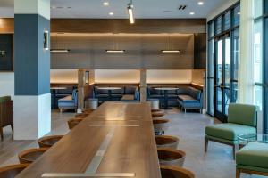 a large communal table in a restaurant with chairs at Courtyard Lewiston in Lewiston +50 photos