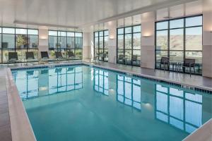 a swimming pool with blue water in a building at Courtyard Lewiston in Lewiston