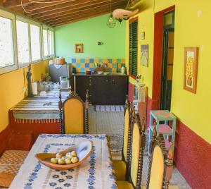 a kitchen with a table with a bowl of fruit on it at La Maison ZiaZen in Porto da Cruz
