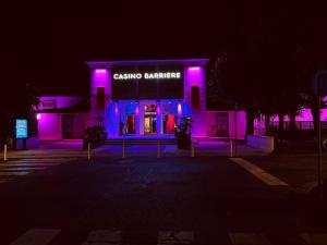 a building with purple lights in front of it at LoveroomL1TIMISTE TAR in La Rochelle