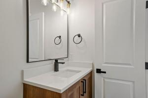 a bathroom with a white sink and a mirror at The Enchanted Summit in Cripple Creek +68 photos