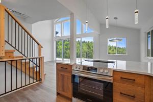a kitchen with a stove and some windows at The Enchanted Summit in Cripple Creek