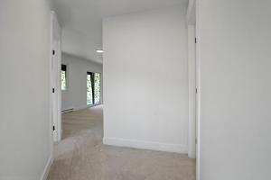 an empty room with white walls and concrete floors at The Enchanted Summit in Cripple Creek