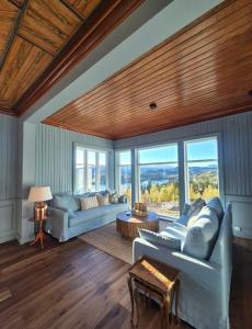 a living room with two couches and a table at Rent your own Boutiqe hotel in Skammestein +48 photos