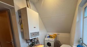 a small bathroom with a sink and a washer at Wohnung Arton in Möhlin