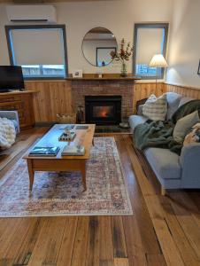 a living room with a couch and a coffee table at Quentin's Cottage in Queenstown