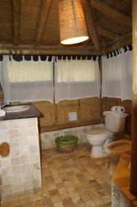 a bathroom with a toilet and a sink at Casitas en Vichayito, a Pasos de la Playa in Los Órganos