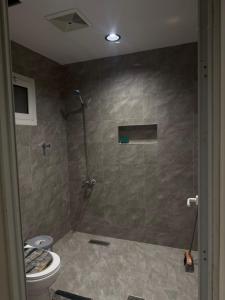 a bathroom with a shower and a toilet at شقة مفروشة in Jazan