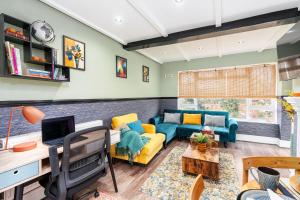 a living room with a couch and a table at The Cozy Corner near NEC Birmingham Airport Entire Apartment Work Desk in Kingshurst