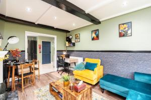 a living room with a couch and a table at The Cozy Corner near NEC Birmingham Airport Entire Apartment Work Desk in Kingshurst
