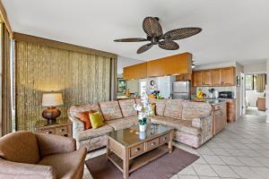 a living room with a couch and a table at Mahina Surf 117 in Honokowai
