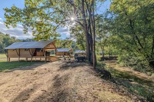 a cabin in the woods with a picnic table and trees at Nature Retreat Cozy tentHVACSpa Bath in Newport