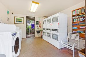 a laundry room with a washer and dryer at Mahina Surf 117 in Kapalua