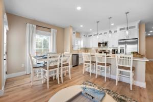 a kitchen and dining room with a table and chairs at 240 Olive Shell Court in Hilton Head Island