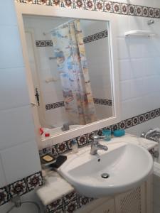 a bathroom with a sink and a mirror at Tulip in Sousse +4 photos