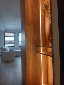 a wooden cabinet in a living room with a couch at Casa Larrea in Cuenca
