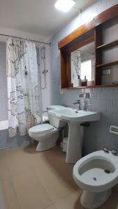 a bathroom with a sink and a toilet and a mirror at Tongoy Bauhaus - Alojamiento hasta 12 personas in Tongoy +41 photos