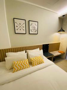 a bedroom with a bed with two clocks on the wall at Mixx Express Hotel Sunway in Petaling Jaya +75 photos