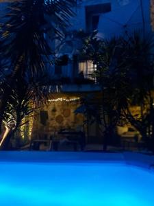 a view of a building with palm trees in the foreground at Chambre d'hôtes Gard in Meynes +6 photos