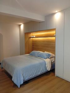 une chambre avec un grand lit avec une tête de lit en bois dans l'établissement Casa Larrea, à Cuenca
