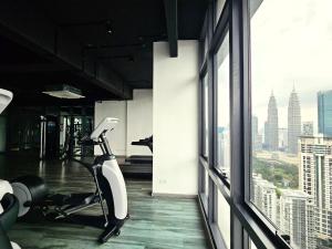 a gym with a treadmill and a view of the city at Panorama luxury Suites At TM Persiaran Stonor KLCC in Kuala Lumpur
