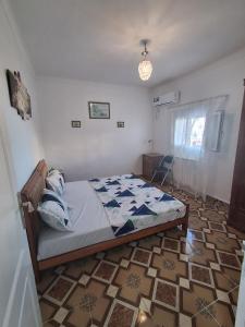 a bedroom with a bed and a tiled floor at villa Mauresque vue sur la baie d'Alger 
