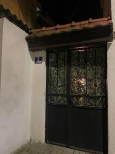 a black door with a gate on the side of a building at TRUTH Apartment Veles in Veles