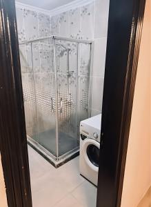 a bathroom with a washing machine and a washer at Stylish Flat at Jannah Compound Sheikh Zayed in Sheikh Zayed +36 photos