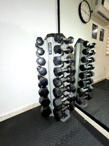 a rack of boxing equipment in a room with a clock at Quality Inn Mazatlan in Mazatlán