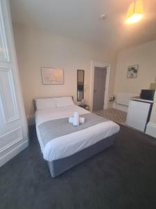 a bedroom with a bed with two candles on it at Park Place Collection in Sunderland