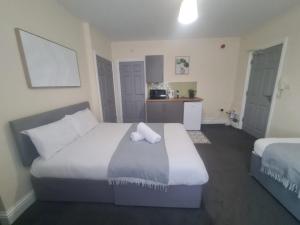a hotel room with a bed and a kitchen at Park Place Collection in Sunderland