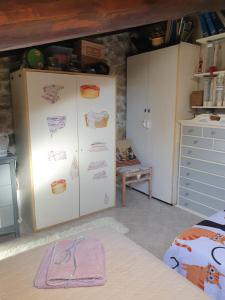 a kitchen with a refrigerator with drawings on it at Creativ hause in San Giuliano Terme