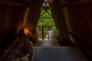 een slaapkamer met een bed en een groot raam bij Wilpattu Safari Resort in Wilpattu