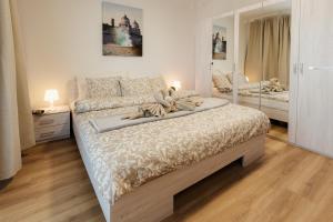 a bedroom with a large bed with a mirror at BNB Sklenarova Apartment with Balcony in Trnávka