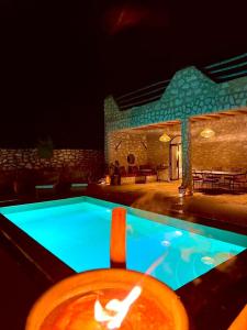 a swimming pool in front of a house at night at Villa Momo Kaouki in Essaouira