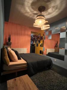 a bedroom with a bed and a chandelier at Plantkot, a cozy apartment full of plants of tinykot in Keerselaar +6 photos