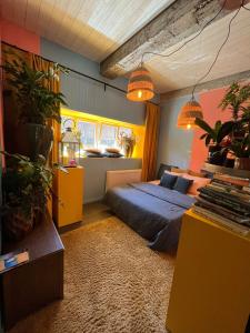 a bedroom with a bed and some potted plants at Plantkot, a cozy apartment full of plants of tinykot in Keerselaar