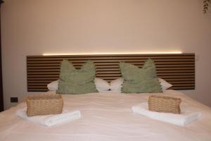 a large white bed with two pillows on it at La Piazzetta Apartment in Pietralunga