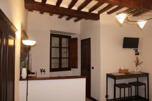 a kitchen with a counter and stools in a room at La Piazzetta Apartment in Pietralunga