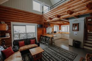 a living room with a couch and a table at Alpine Haven, Peaceful , Stunning Views - ML21396 in Mt Lyford