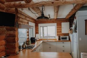 a kitchen with wooden walls and a counter top at Alpine Haven, Peaceful , Stunning Views - ML21396 in Mt Lyford