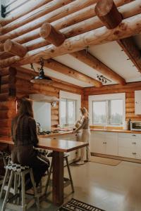 two women in a kitchen in a log cabin at Alpine Haven, Peaceful , Stunning Views - ML21396 in Mt Lyford