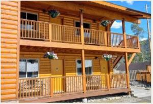 a large log cabin with a large deck at Lone Eagle Lodge in Grand Lake