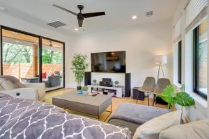 a living room with a bed and a tv at Chic Austin House with Spacious Backyard and Hammock in Austin