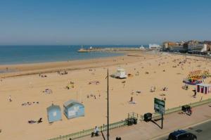 a beach with a lot of people on it at Beach Next Door Flat Retreat and Free Parking in Margate