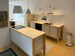 a kitchen with a sink and a refrigerator at Town House With Sea View In Historic Ærøskøbing in Ærøskøbing