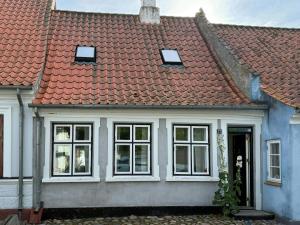 a blue and white house with a red roof at Town House With Sea View In Historic Ærøskøbing in Ærøskøbing